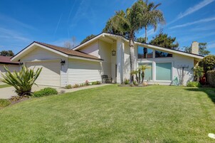 A single-story house with a garage, a small porch, and a well-maintained lawn.