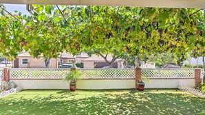 A patio with artificial grass, a white lattice fence, and potted plants. - Romantic Pasadena Home w/ Covered Porch! (Pasadena)