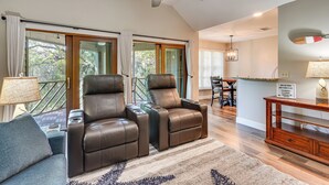 A spacious living room with two leather recliners, a coffee table, and a ceiling fan. - Blissful Kiawah Island Escape: Walk to the Beach! (Kiawah Island)