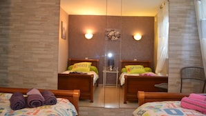 Habitación de hotel con dos camas, un espejo y una silla.