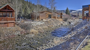 A cabin-style lodging with a wooden exterior, a porch, and a view of a river and mountains. - 6 Mi to Slopes! Mtn-view Breck Gem w/ Resort Perks (Breckenridge)