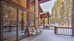 A wooden deck with snow-covered chairs and a glass door leading to a snowy landscape. - Blue River Home w/ Hot Tub, 6 Mi to Skiing! (Breckenridge)