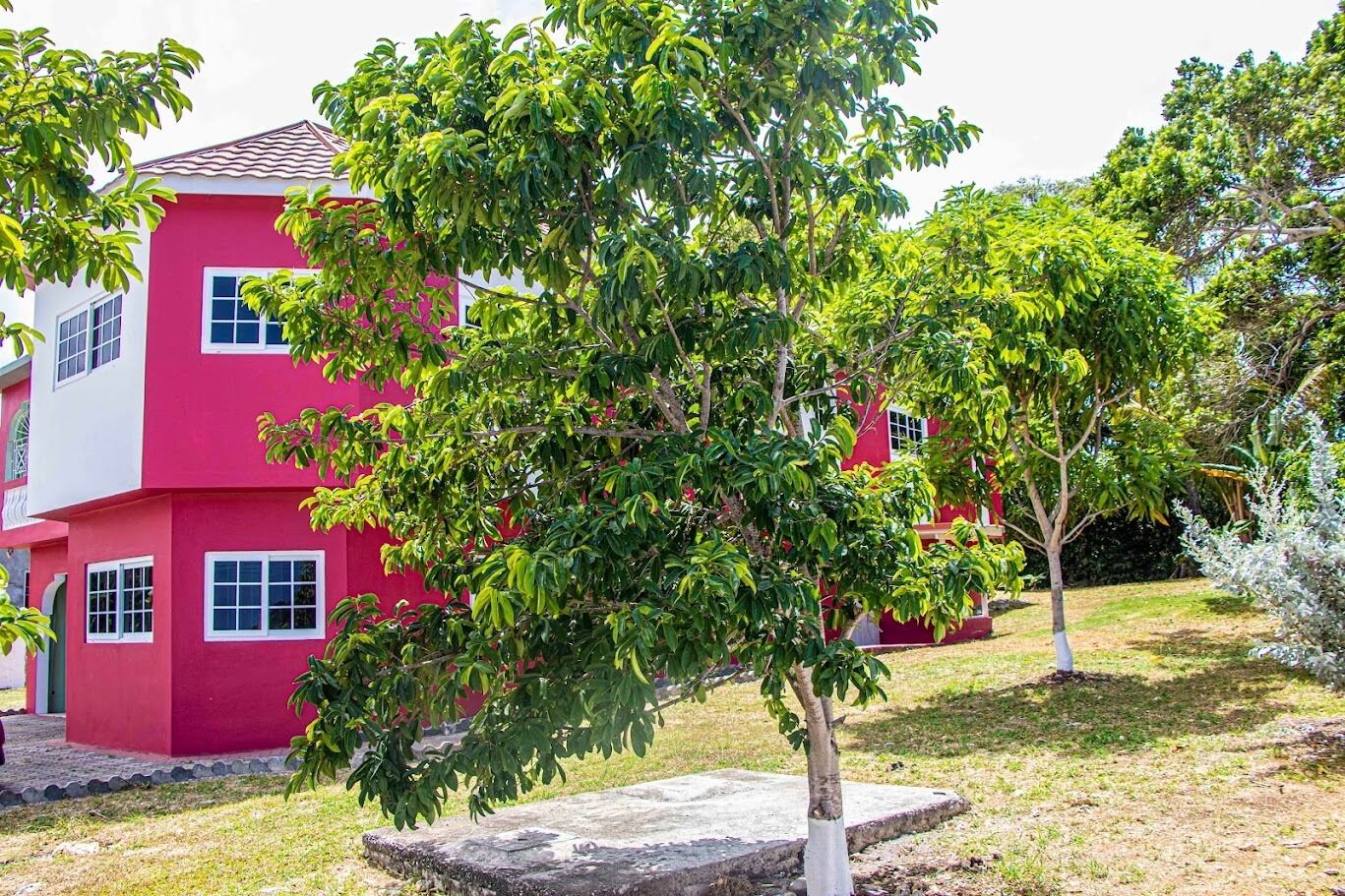 A two-story building with a red facade and multiple windows.