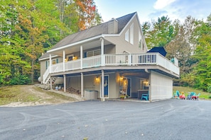 A two-story house with a porch, a covered front porch area, and a garage.