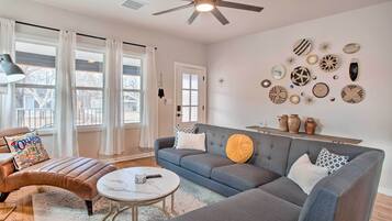 Relax in this stylish living room with a large sectional sofa, coffee table, and comfortable leather ottoman.