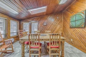 A wooden-paneled room with a large table and chairs, a ceiling fan, and a decorative wall piece. - Ruidoso Condo w/ Hot Tub: Long Walk to Midtown! (Ruidoso)