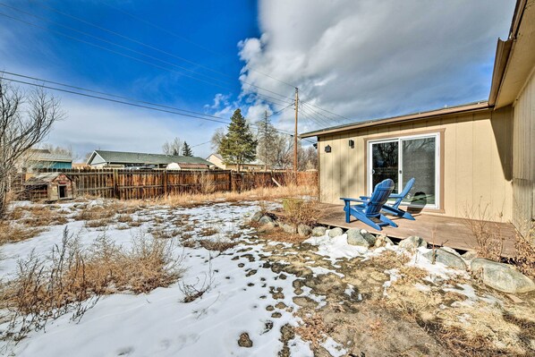 A house with a covered porch and a blue chair.
