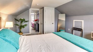 A bedroom with a large bed, a potted plant, a desk, and a wardrobe. - Charming Mcminnville Home - Walk to Wineries! (McMinnville)