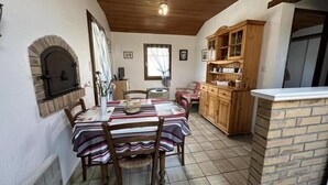 A dining area with a brick oven, wooden cabinets, and a tiled floor. - Le Tastet - Saint LON LES Mines (SAINT LON LES MINES)