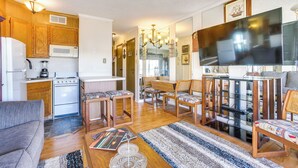A compact living space with a kitchen, dining area, and seating.