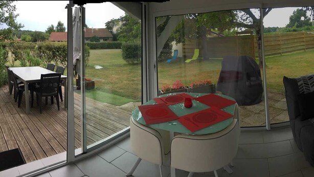 A modern living room with a glass sliding door leading to a garden. - Erable - Ste-eulalie-en-born (STE-EULALIE-EN-BORN)