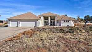A two-story house with a garage, a covered entryway, and a landscaped front yard. - Grand Junction Mountain Escape w/ Grill! (Grand Junction)