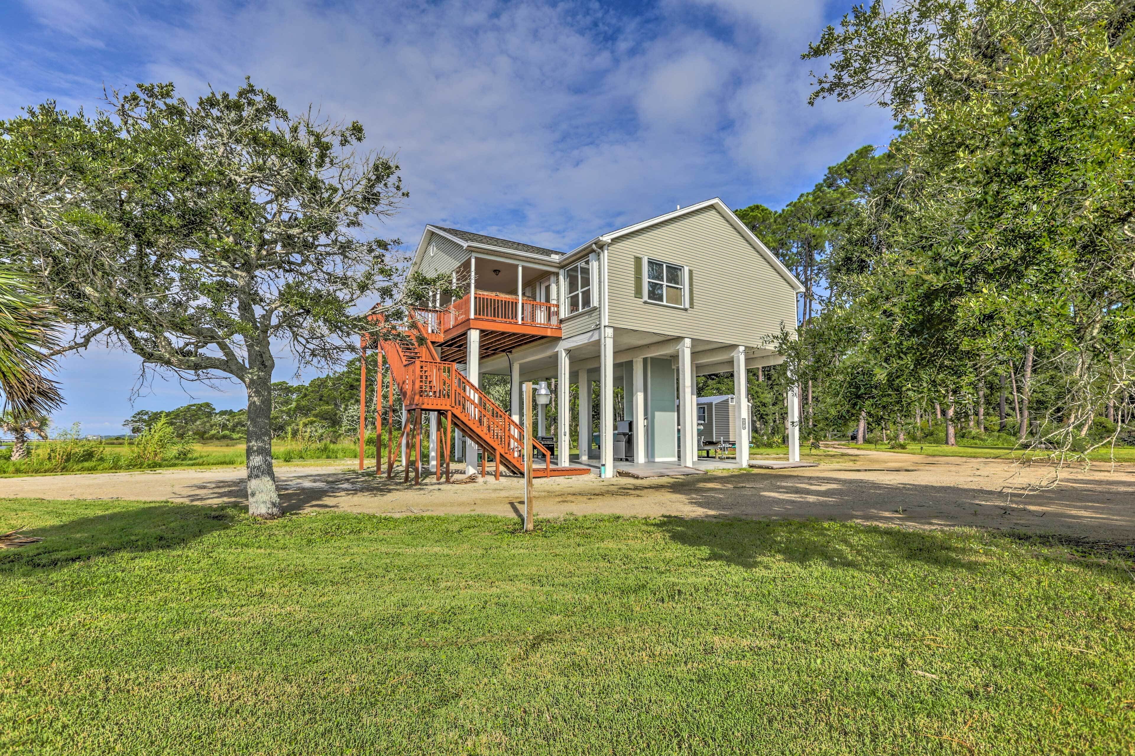 A two-story house with a balcony and a staircase leading to an upper level.