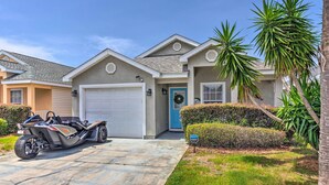 A residential house with a garage, a driveway, and a parked motorcycle. - PCB Retreat w/ Patio & Grill < 1 Mi to Beach! (Panama City Beach)