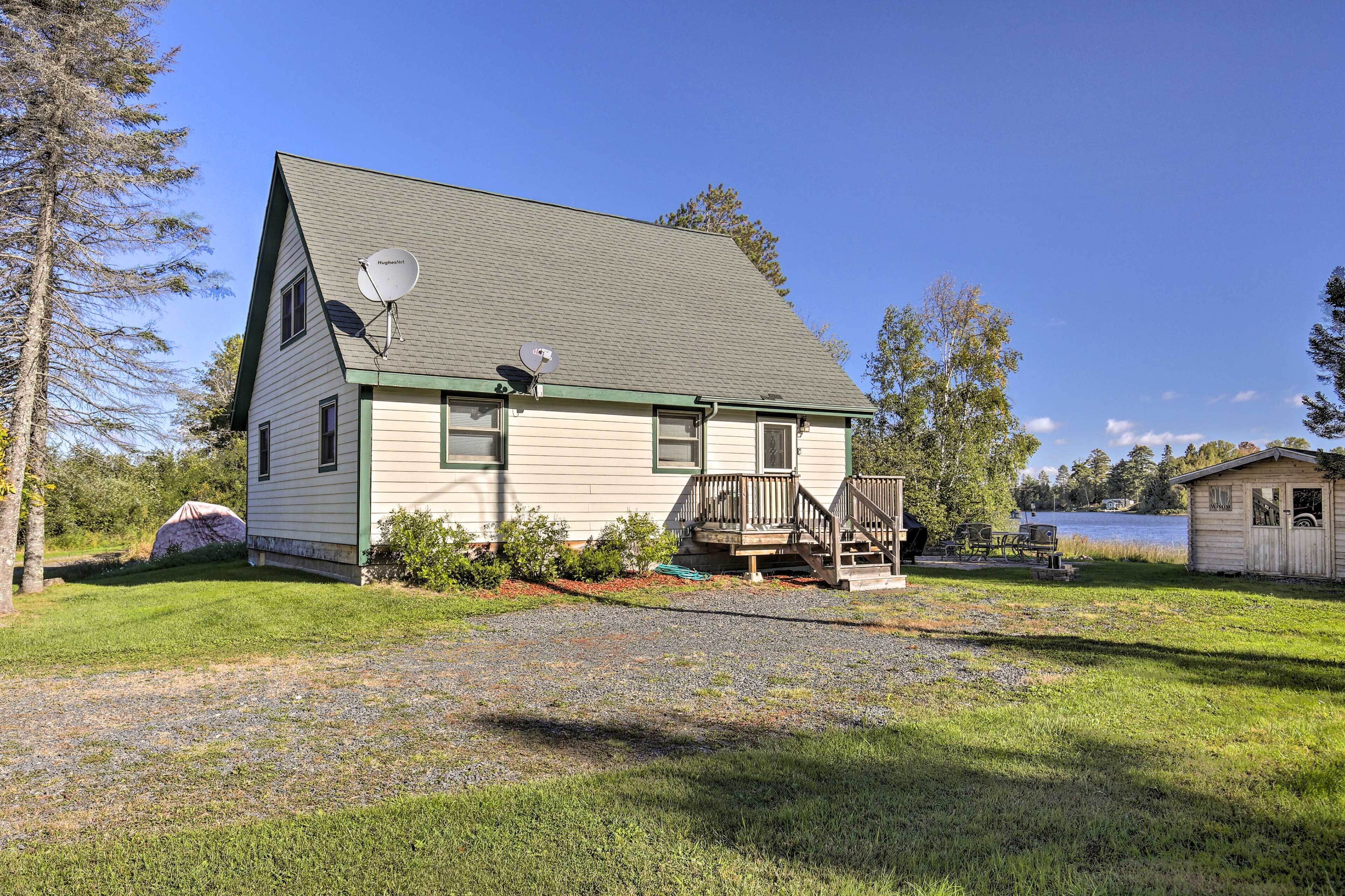 A single-story house with a green roof and a satellite dish.