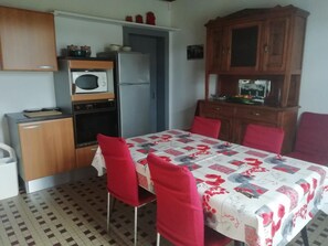 Enjoy meals in the kitchen with a microwave, refrigerator, and oven. Dine at the adjacent table with comfortable seating for four.