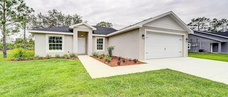 A single-story house with a garage, a front porch, and a well-maintained lawn.