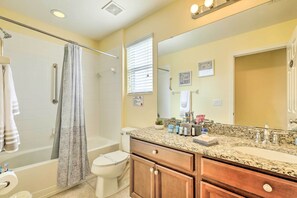 A bathroom with a shower, toilet, vanity with a mirror, and toiletries. - Riverview Abode w/ Large Backyard & Fire Pit! (Riverview)