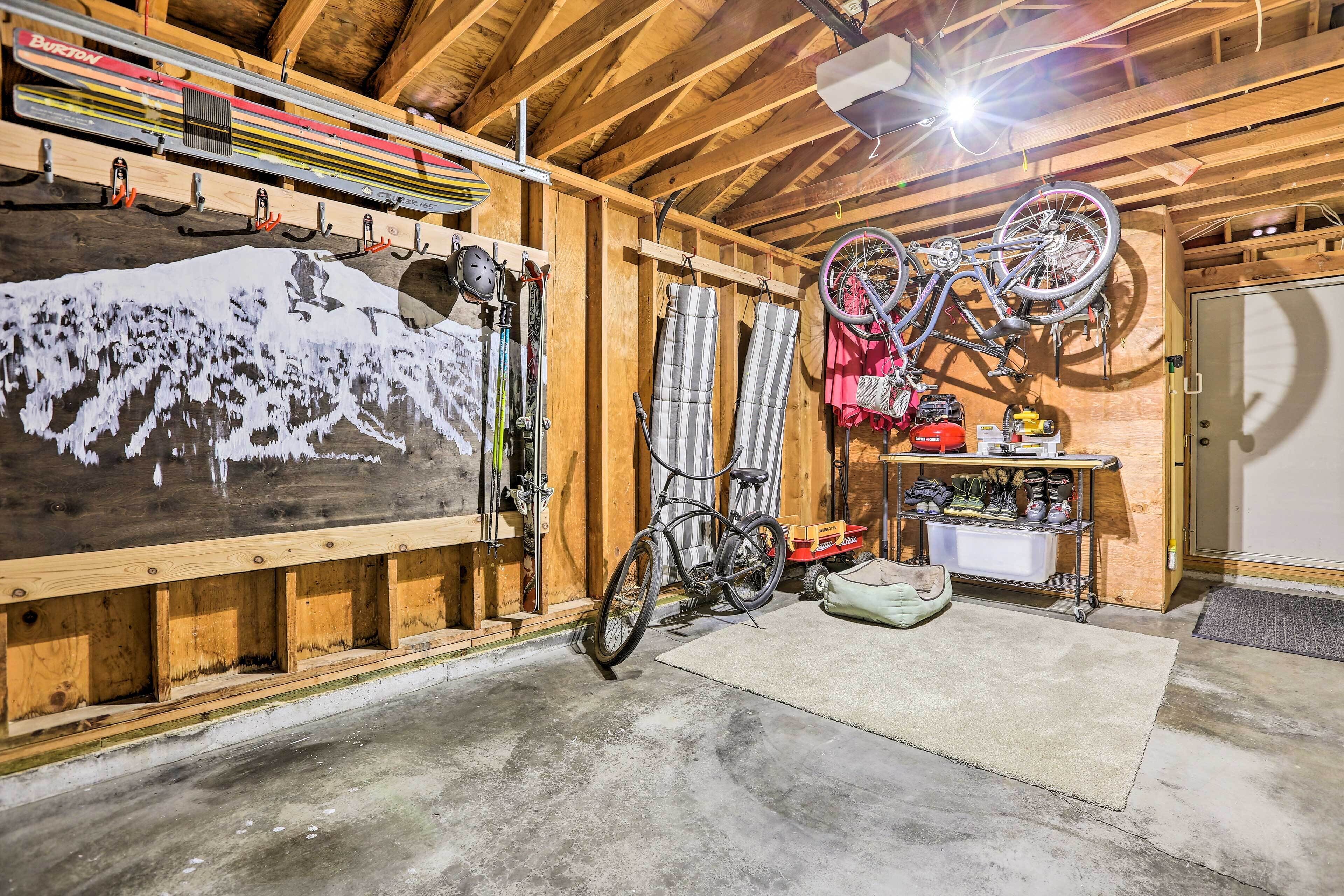 A wooden interior with a ski rack, a bicycle, and a wall-mounted ski lift.