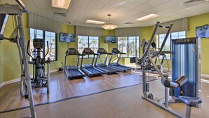 A gym with treadmills, weight machines, and exercise mats. - Resort Getaway w/ Patio: 6 Mi to Disney Parks! (Kissimmee)