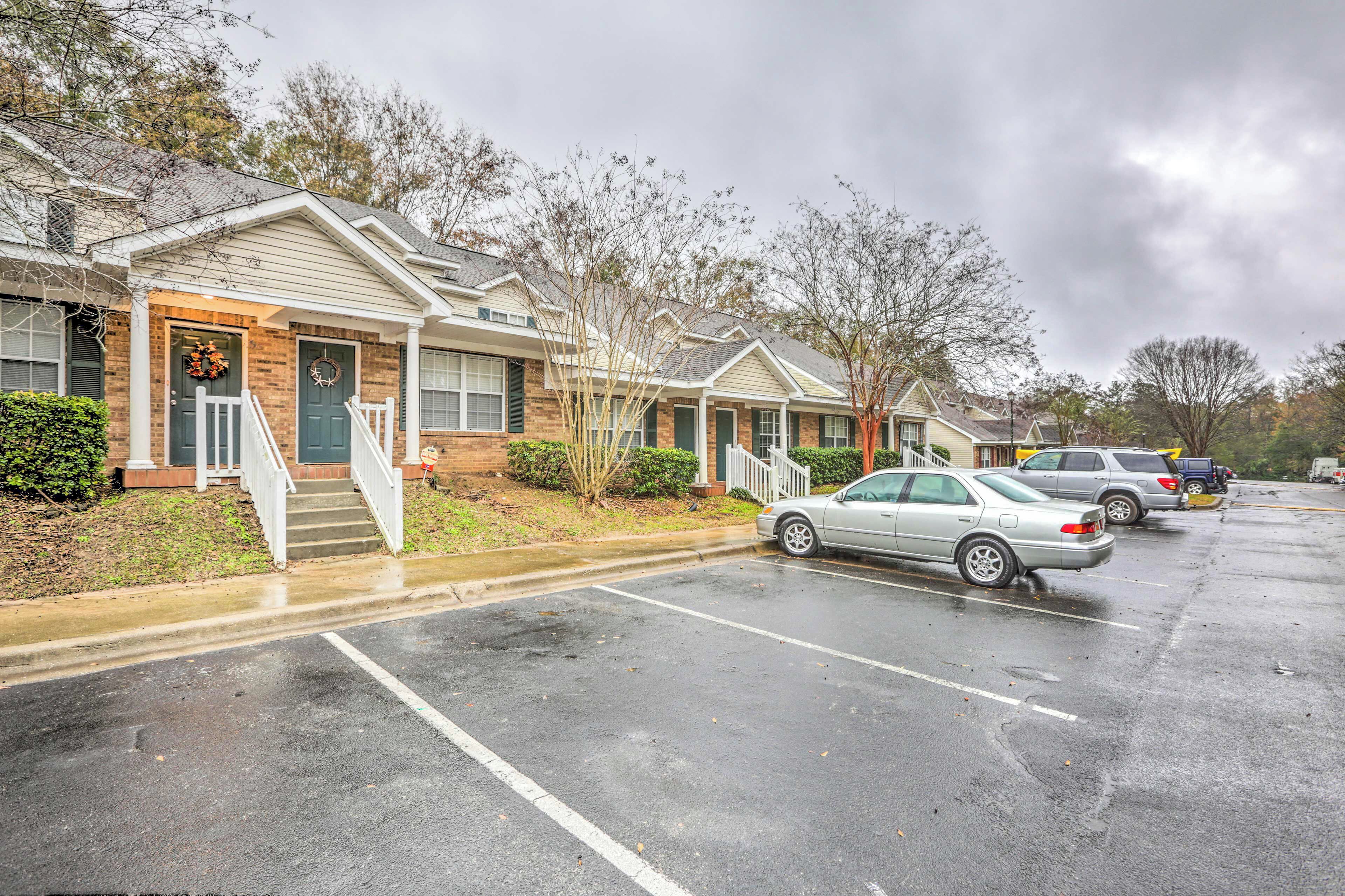 A row of townhouses with front porches and steps leading to the entrance.