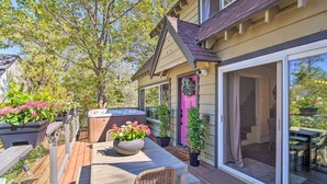 A deck with a hot tub, outdoor seating, and potted plants. - Chic Lake House w/ Furnished Deck & Hot Tub! (Cedar Glen)