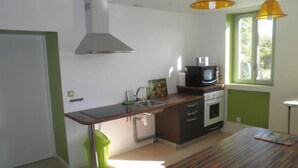 Een moderne keuken met een houten aanrecht, een magnetron en een spoelbak.