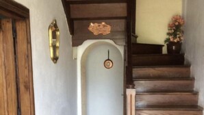 A wooden staircase with a handrail leading to a landing.