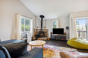 A living room with a fireplace, a television, and a sofa.
