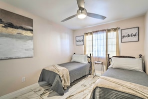 A bedroom with two beds, a ceiling fan, a painting, and two motivational posters. - Walkable Location! Las Vegas Apt: 11 Mi to Strip (Las Vegas)
