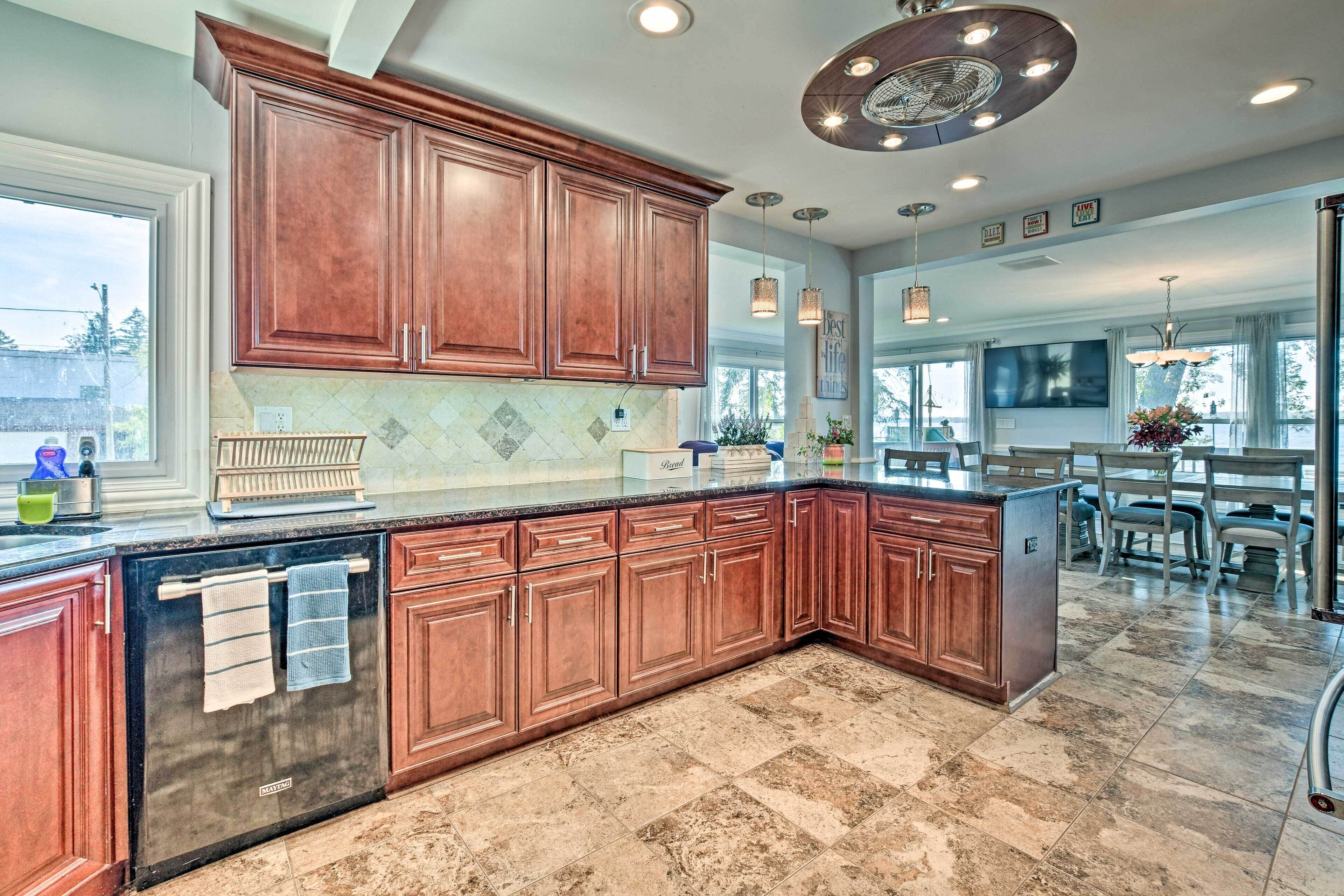 A spacious kitchen with wooden cabinets, a built-in oven, and a large island.