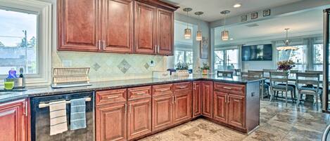 A spacious kitchen with wooden cabinets, a built-in oven, and a large island.