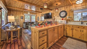 A wooden interior with a kitchen, dining area, and living room. - < 3 Mi to Lake: Pet-friendly Big Bear Cabin (Big Bear Lake)