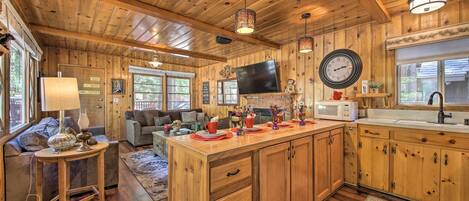 A wooden interior with a kitchen, dining area, and living room.
