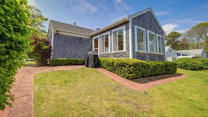 A house with a covered outdoor area, a brick pathway, and well-maintained hedges. - 1 Mi to Beach: Quiet West Dennis Escape w/ Sunroom (West Dennis)