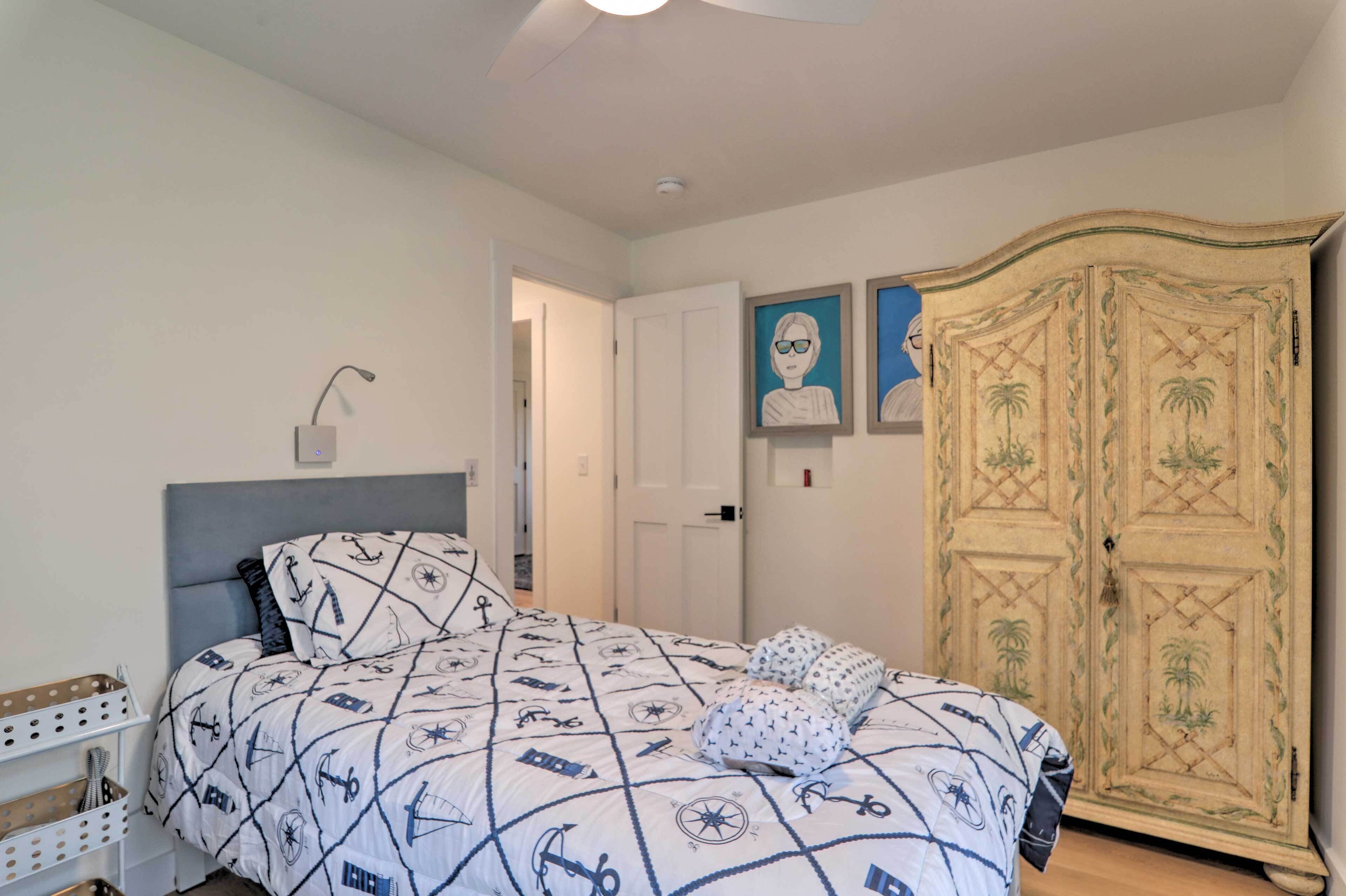 A bedroom with a bed, a wardrobe, and a nightstand.