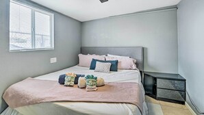 A bedroom with a bed, bedside tables, a ceiling fan, and a window. - North Las Vegas Studio w/ Fire Pit: 10 Mi to Strip (North Las Vegas)