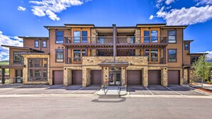 A multi-story building with a stone facade, large windows, and a central entrance with a covered walkway. - 3 Mi to Dillon Reservoir: Condo w/ Balcony! (Silverthorne)