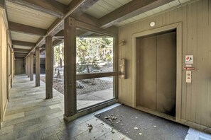 A wooden interior with a glass door leading outside, a no smoking sign, and a tiled floor. - 1 Mi to Trail: Wfh-friendly Incline Village Condo! (Incline Village)