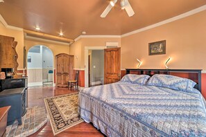 A bedroom with a large bed, wooden wardrobe, and a desk. - Sault Ste Marie Historic Home, Walk to Town! (Sault Ste. Marie)