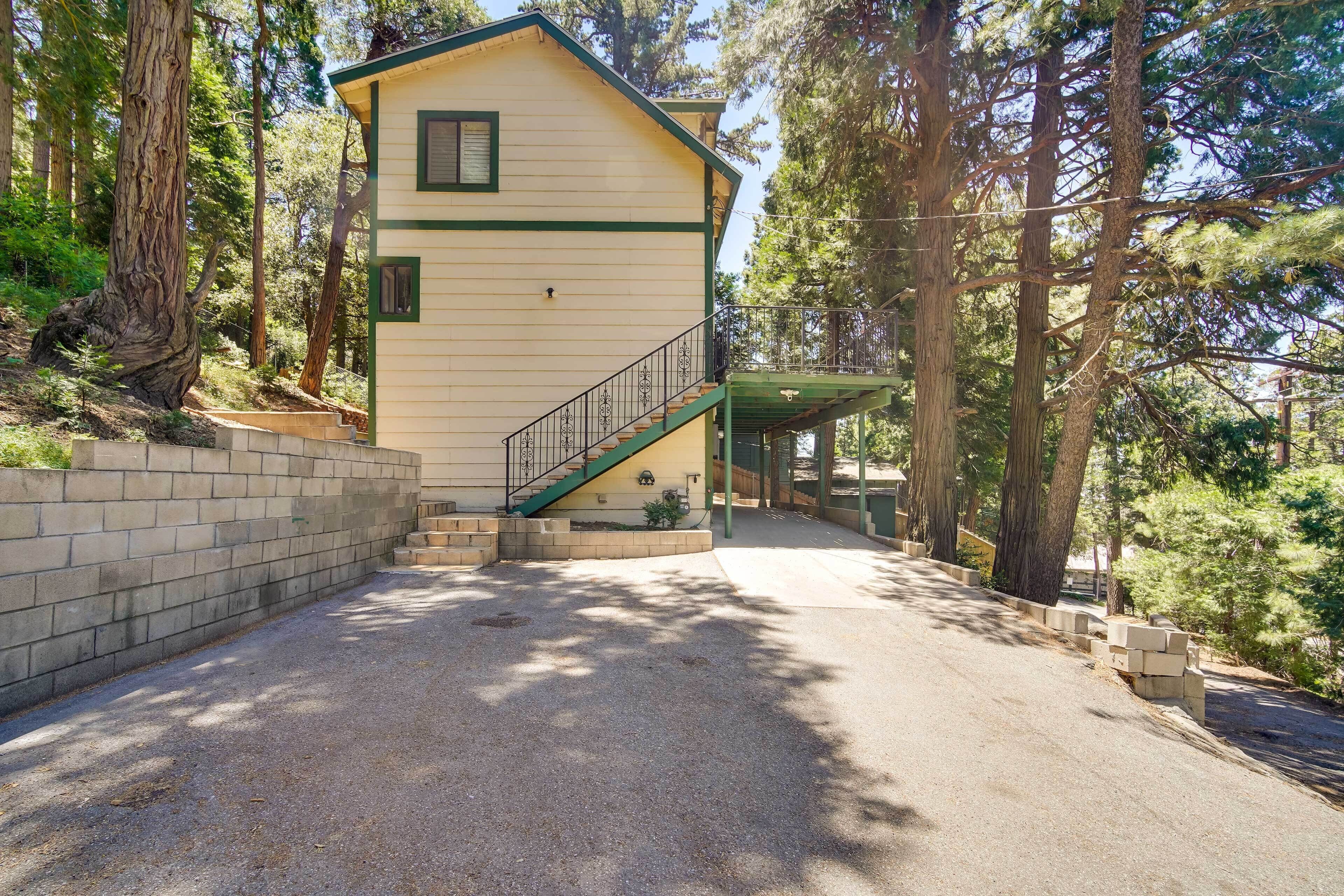 A two-story building with a green exterior and a staircase leading to the upper floor.