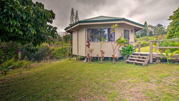 A small, single-story building with a green roof, surrounded by lush greenery and a well-maintained lawn. - Hilo Couples Retreat ~ 6 Miles to Honoli'i Beach! (Hilo)