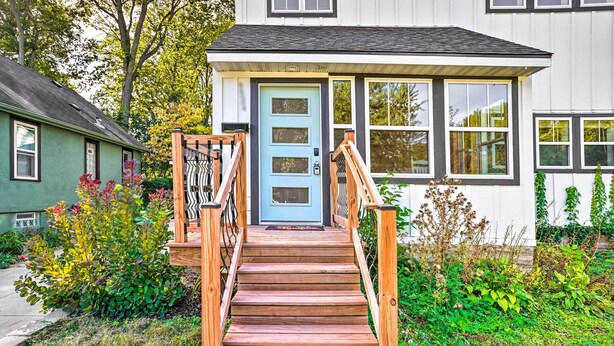A wooden staircase leading to a light blue door with a small porch. - Pet-friendly Minneapolis Home ~ 6 Mi to Dtwn! (Minneapolis)