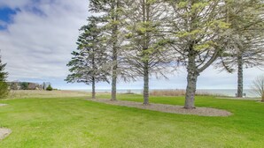 A grassy park area with several trees and a bench. - Waterfront Algoma Vacation Rental on Lake Michigan (Algoma)