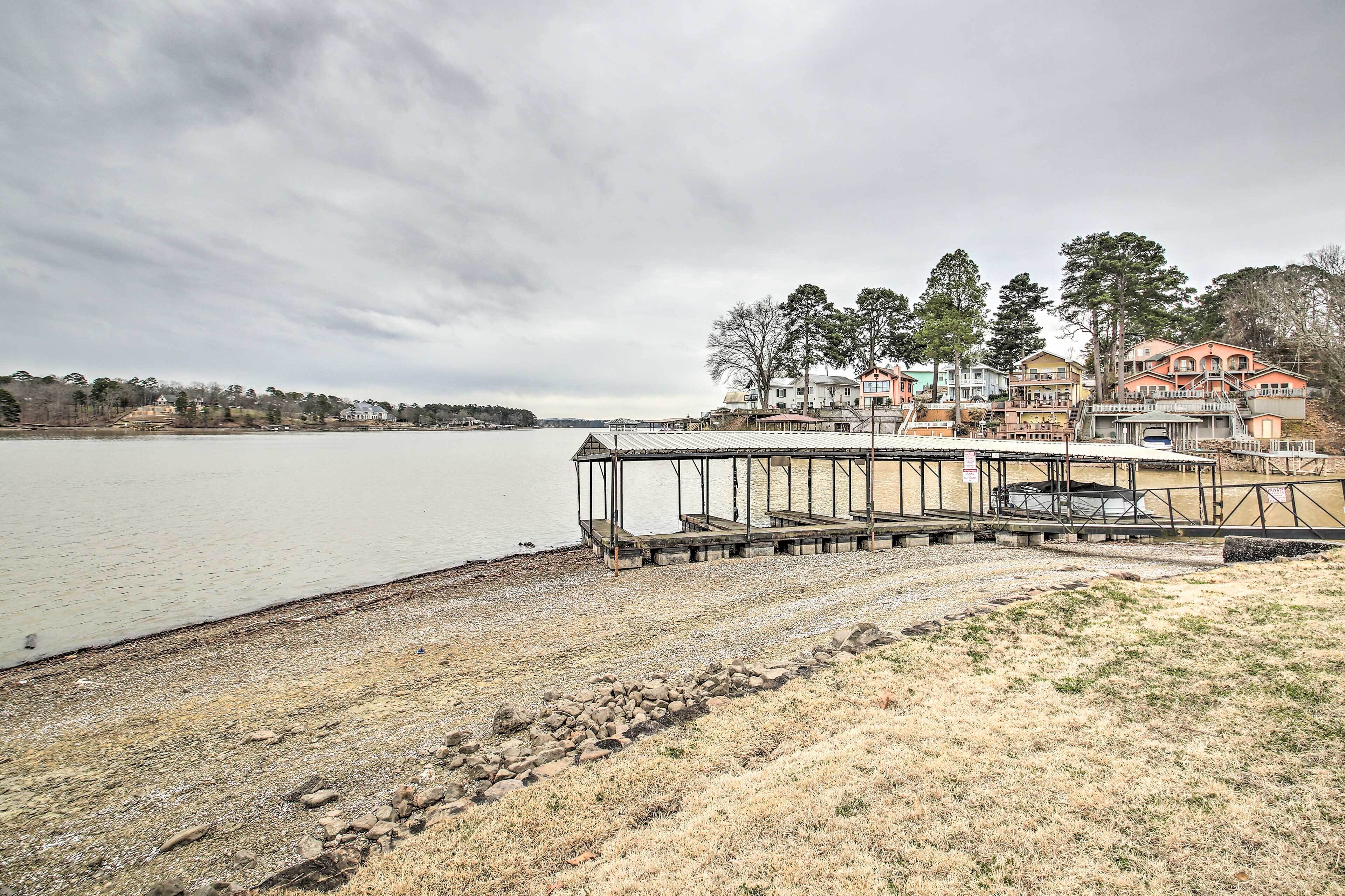 A lakeside property with a dock, a gazebo, and a row of colorful houses.