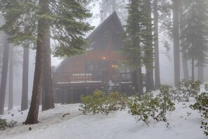 A cabin with a deck, surrounded by tall trees and covered in snow. - 2 Mi to Northstar Resort: Idyllic Cabin w/ Shuttle (Truckee)