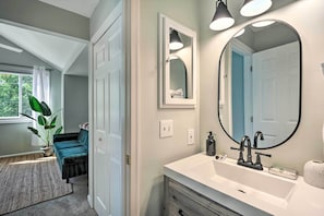 A bathroom with a large mirror, a white sink, and a potted plant. - Annapolis Vacation Home: 2 Mi to Quiet Waters Park (Annapolis)