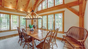 A spacious dining area with a large wooden table surrounded by chairs, large windows, and a wooden ceiling. - 7 Mi to Rocky Mtn Nat'l Park: Grand Lake Home! (Grand Lake)