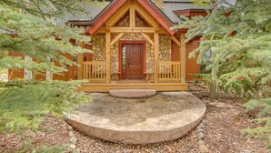 A cabin with a stone facade, wooden porch, and a circular stone platform in front. - 7 Mi to Rocky Mtn Nat'l Park: Grand Lake Home! (Grand Lake)