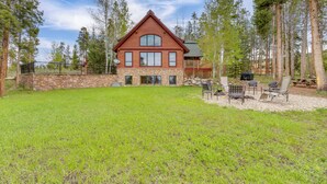 A two-story log cabin with a stone foundation, surrounded by a well-maintained lawn and tall pine trees. - 7 Mi to Rocky Mtn Nat'l Park: Grand Lake Home! (Grand Lake)